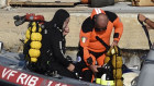 Scuba divers at the harbour of Porticello, southern Italy.