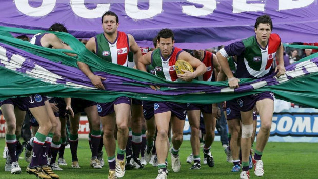 Josh Carr (centre) in his playing days for Fremantle with Justin Longmuir (right). The two have been reunited at the Dockers as coaches.