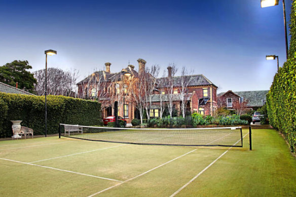 The estate has a tennis court and manicured gardens.