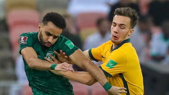 Australia’s Denis Genreau wrestles Mohammed Al-Breik for the ball in Jeddah.
