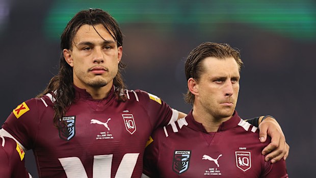 Tino Fa'asuamaleaui and Cameron Munster of the Maroons line up for the national anthem.