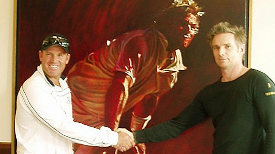 Artist Jamie Cooper posing with Shane Warne and his his first portrait of the late spinner.
