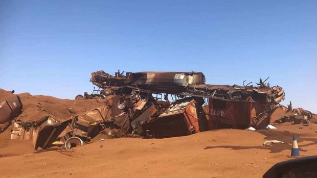 The crash turned the train and its wagons into a mess of crumpled metal and spilled iron ore.