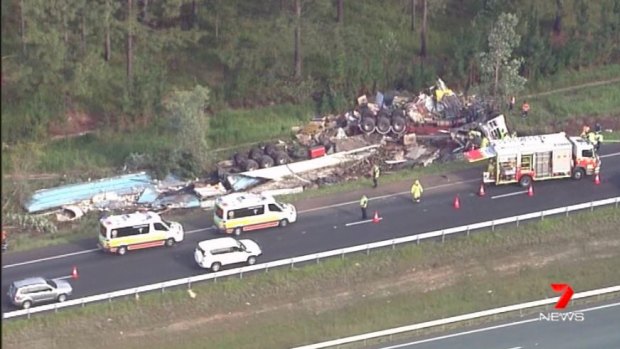 A man in his 40s was trapped inside his truck when it rolled off the Bruce Highway. 