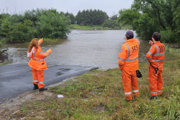 SES volunteers survey flooding in Gippsland.
