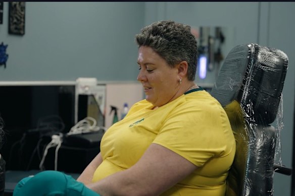 Chef de mission Petria Thomas prepares to get her new tattoo.