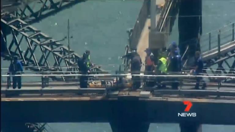 A woman was evacuated from the top of the Harbour Bridge after suffering heat exhaustion.