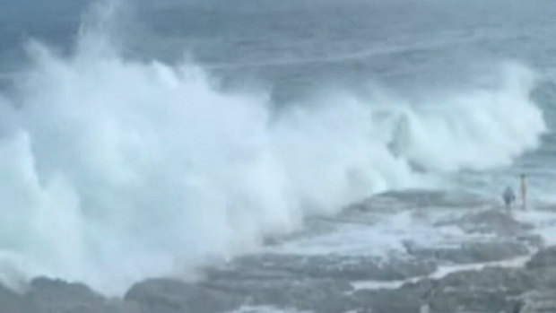 The large wave crashed onto rocks where the couple was walking, pulling them into the sea.