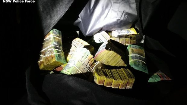 Police allegedly seized $1 million in cash, stashed inside a sports bag in the boot of the car. 
