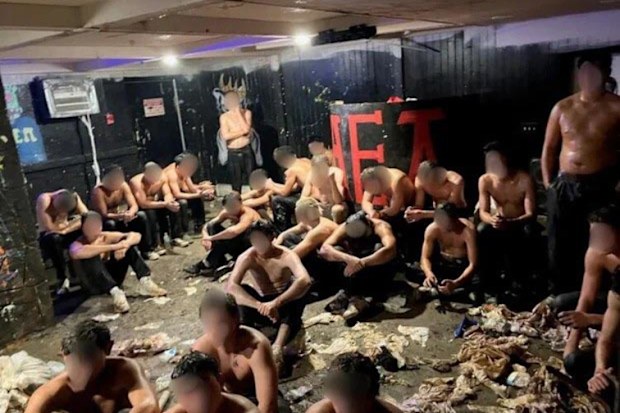 Two 20-year-olds were arrested after police were called to the scene of an alleged hazing incident where over two dozen young men were partially clothed and covered in liquids in America.