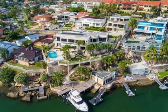 The waterfront property spreads across three lots, and has a private deepwater jetty with two pontoons and a boathouse.