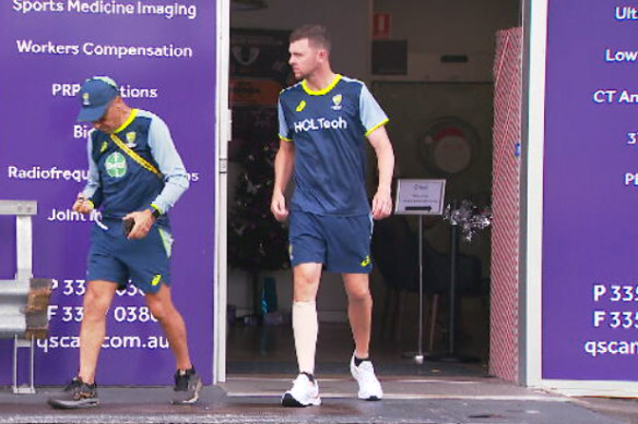 A despondent Josh Hazlewood wears a compression bandage on his calf.