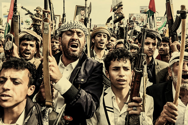 Yemenis with rifles and Houthi emblems show solidarity with Palestinian people on August 9 in the capital, Sanaa. 