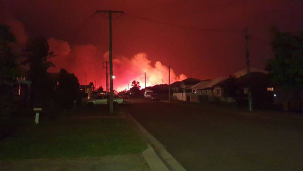Emergency crews battle a bushfire near homes at Belmont on Thursday night.