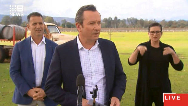 Mark McGowan, accompanied by Tourism Minister Paul Papalia, addresses reporters in the Swan Valley on Monday.