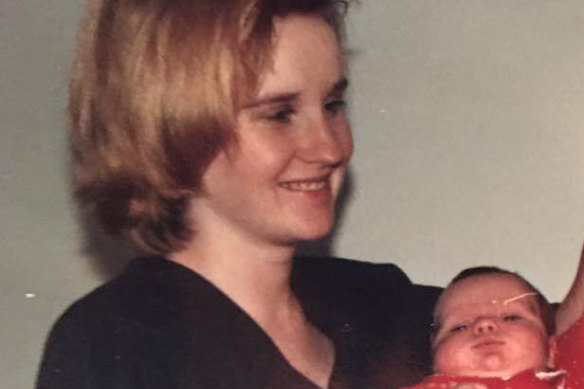 With her newborn in February 1989