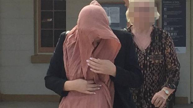 DISQUALIFIED: Caroline Ashthore Throwden (face covered) leaves Raymond Terrace Local Court on Monday after pleading guilty to high-range drink driving while picking up her daughter from school.