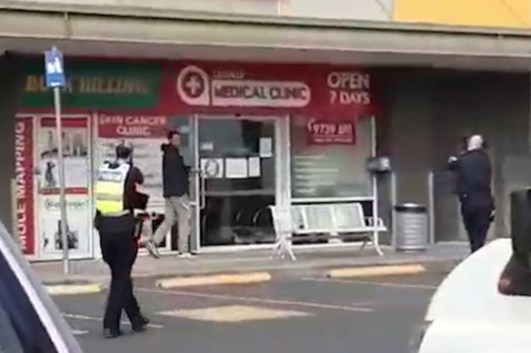 Police surround a man armed with a knife in Lilydale on Tuesday. 