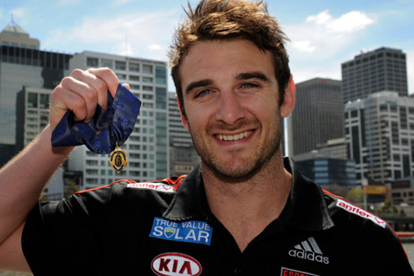 Essendon skipper Jobe Watson holds the Brownlow, which was later taken from him.