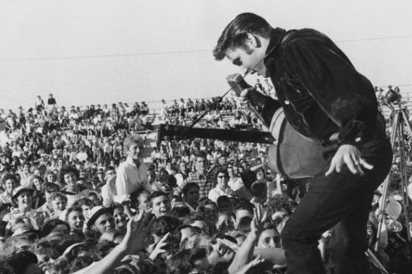 A young Elvis Presley heralded the explosion of rock and roll as the dominant form of popular music.