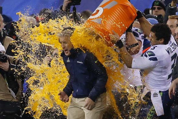 Russell Wilson dumps Gatorade on Seahawks head coach Pete Carroll.