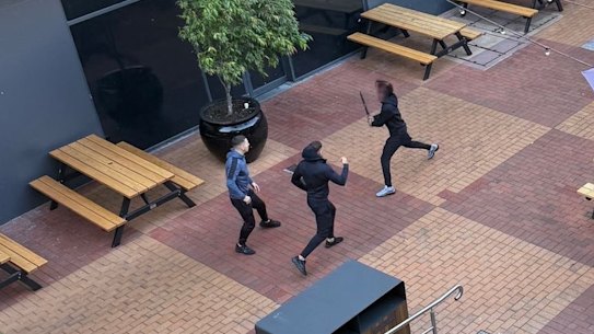 A photo taken by witnesses at Northland shows a person wielding a knife lunging at two other people.