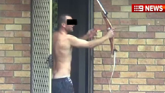 A topless man with a bow and arrow takes on police wearing ballistic vests and armed with  high-powered guns. Who would you back?
