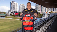Bears coach Mal Meninga holding the jersey.