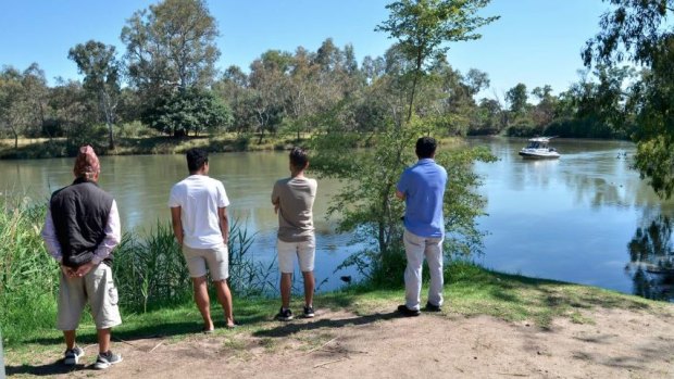 Distraught family and friends watch emergency services search for Bigul Pandit in the Murray River.