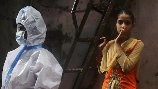 Health workers screen residents for COVID-19 symptoms at Dharavi, one of Asia's biggest slums, in Mumbai, India, Monday, Aug. 3, 2020. India is the third hardest-hit country by the pandemic in the world after the United States and Brazil. (AP Photo/Rafiq Maqbool)