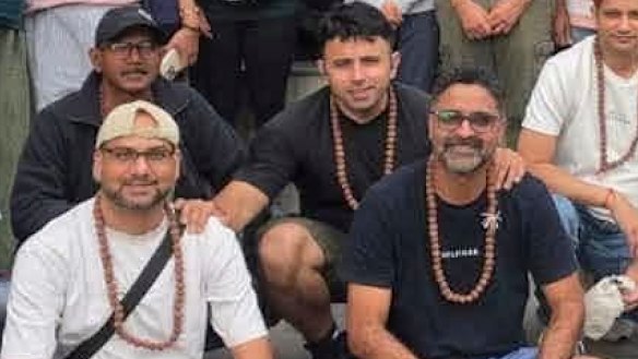 Missing Brisbane father Karan Bhardwaj holdings the shoulders of his friends, Arpan Mithalal Kothari (L) and Bhavinkumar Rajnikant Raval (R) shortly before departing with the Kailash Journeys tour group. The Australian trio have not been heard from since.