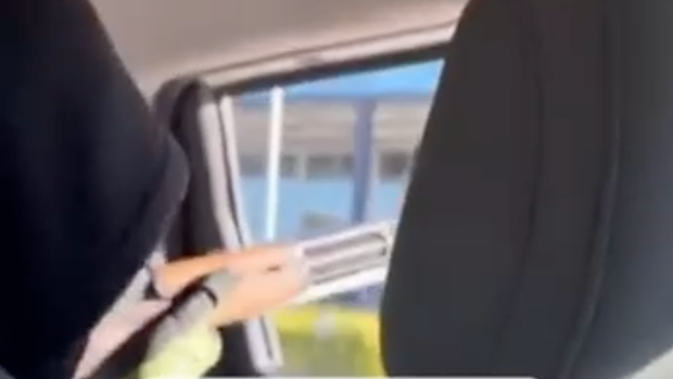 The footage shows a hooded gunman firing shots out a car window.