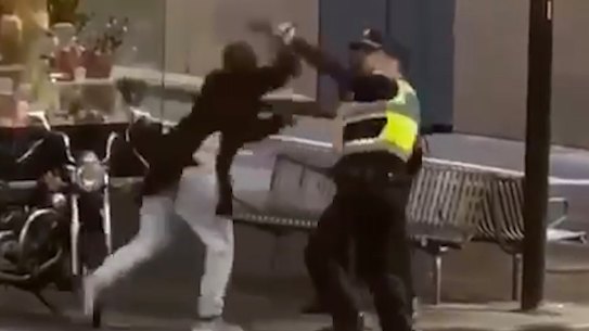 Police confront Hassan Khalif Shire Ali in Bourke Street last year.