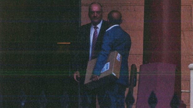 A surveillance photograph shows Joseph Alha, carrying a box with a building model, meeting Daryl Maguire at Parliament in 2017.