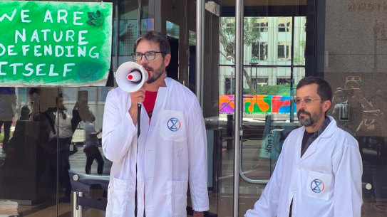 Peter Kalmus (centre), a NASA scientist, says frustration drove him to break the law.