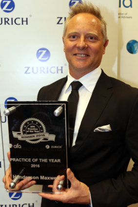 Sam Henderson with his firm's award for "Practice of the Year"