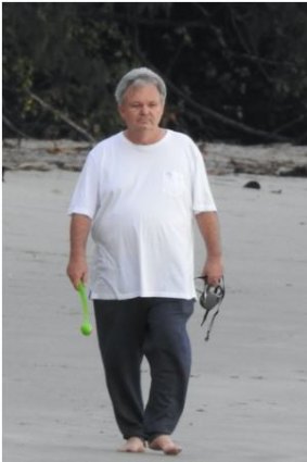 Peter Foster walking the beach in Port Douglas.