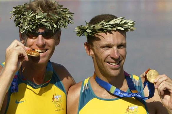 Drew Ginn, right, in a previous sporting life -  celebrating a gold medal with James Tomkin at the Athens Olympics in 2004.