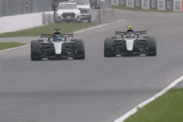 Mercedes car passes a rival in an F1 race.