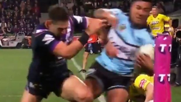 The critical moment: A front-on shot of Billy Slater knocking Sosaia Feki out of play with an apparent shoulder charge.