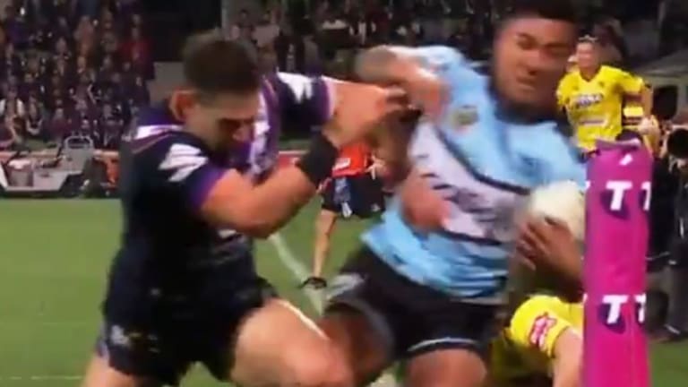 The critical moment: A front-on shot of Billy Slater knocking Sosaia Feki out of play with an apparent shoulder charge.