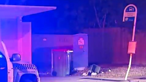 The crash scene in Helensvale, including a dented sign and knocked-over bin.
