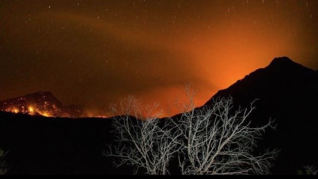 Bushfires move around Mt Barney and close on Mt Barney Lodge, according to lodge owner Innes Larkin. Mr Larkins says climate changes is now making rare rainforest dry and susceptible to bushfires.