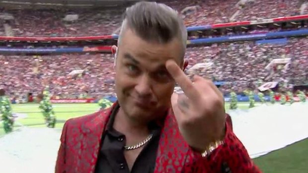 A bit rude: Robbie Williams gives the camera the finger at the end of his performance. 