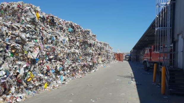 A wall of recycling material, photographed inside one of SKM's western Melbourne facilities the day before it was shut down by the EPA.