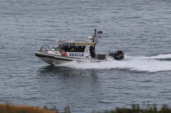 A sea recovery searches for the beach near the NSW boat near Wooli.
