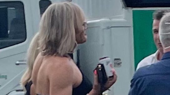 Dani Laidley talking with former North Melbourne captain Anthony Stevens at Geelong Racecourse on Saturday. Ms Laidley gave permission for The Age to publish the image.