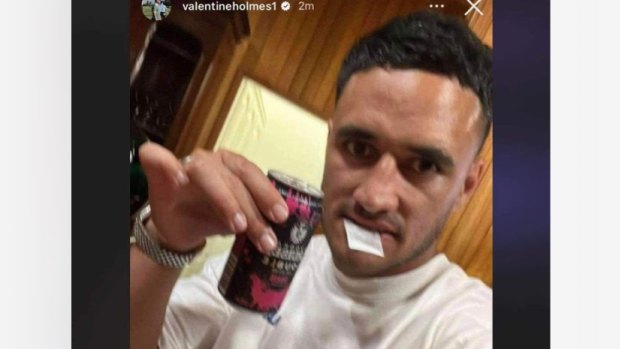 Valentine Holmes with a white bag in his mouth.