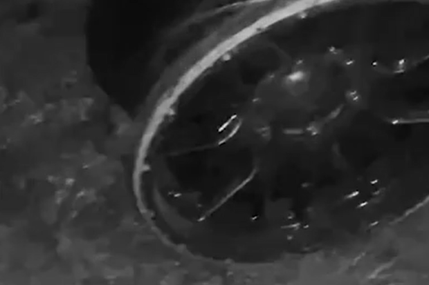 A screenshot from a TikTok video showing a car with bare rims, purportedly filmed by teens.