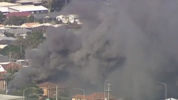 Smoke billows from the fatal house fire in Carina in Brisbane's east.